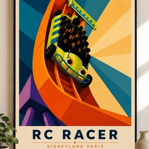 May include: A framed poster featuring a stylised illustration of the RC Racer ride at Disneyland Paris. The artwork depicts a yellow toy car vehicle ascending a bright orange U-shaped track against a background of blue and yellow sunburst rays.