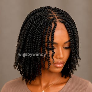 May include: A shoulder-length black wig featuring tightly coiled twists with a defined center part. The hair texture is uniform with small, dense curls throughout. The text "wigsbywendy" is visible in white lettering on the left side of the image.