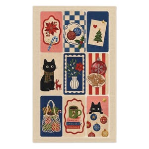 May include: A rectangular kitchen towel featuring a grid of nine illustrations with holiday themes. Designs include a black cat with a scarf, a tote bag with gifts, a mug on books, Christmas ornaments, cookies, a tree, and floral motifs.