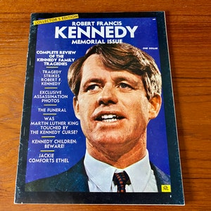 May include: A vintage magazine cover featuring Robert F. Kennedy. The cover is predominantly blue with the title "ROBERT FRANCIS KENNEDY MEMORIAL ISSUE" in white. The cover includes text such as "Complete Review of the Kennedy Family Tragedies" and "Exclusive Assassination Photos."