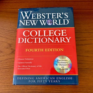 May include: A Webster's New World College Dictionary, Fourth Edition, with a red and blue cover. The book includes a CD-ROM with an electronic dictionary and thesaurus. The cover text reads "Defining American English for Fifty Years."