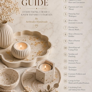 May include: A digital guide titled The Complete Jesmonite Guide by ArtStudio-Handmade, featuring a list of 18 chapters. The image displays cream-colored Jesmonite decor, including a scalloped tray, a bowl, and two candle holders with lit candles.