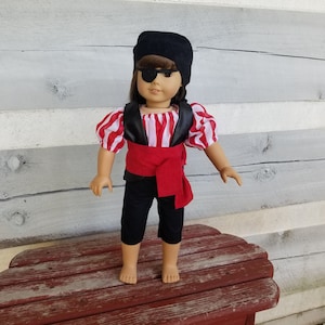 Pirate costume that fits 15 and 18-inch dolls. Outfit includes a shirt, vest, pants, headscarf, eye patch and sash.