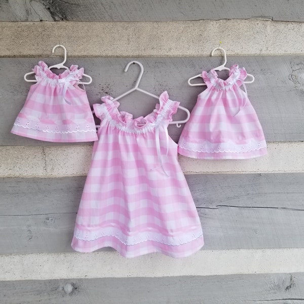 Simply sweet toddler and doll dresses handmade of pink check 100% cotton trimmed with white eyelet lace. Easy on and off, size 1/2T to 4T.