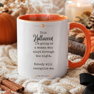 May include: A white ceramic mug with an orange interior and handle, featuring a small pumpkin icon and the text: This Halloween I'm going as a woman who slept through the night. Nobody will recognize me. THE FFF CLUB. The mug is labeled 11oz Orange.