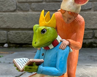 Frog reading ( but now aware of his visitor).