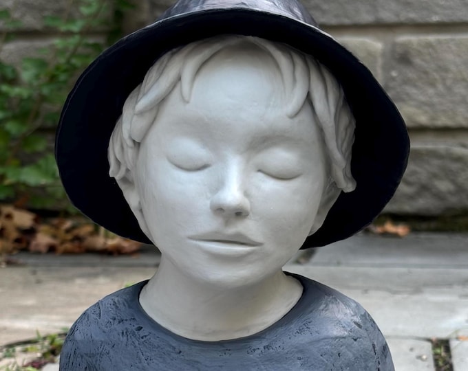 Figure with black hat.