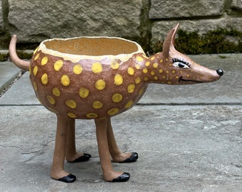 Tall weird animal plant stand.