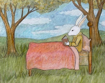 Rabbit reads in field.