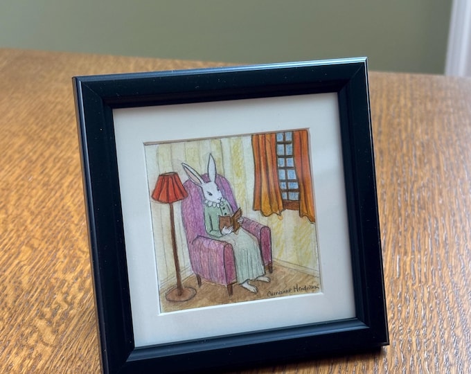 Rabbit reading in chair. Original drawing.