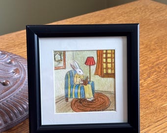 Rabbit reading in chair. Original drawing.