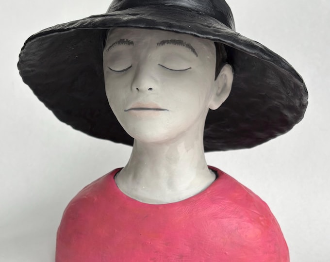 Girl wearing wide brimmed hat.