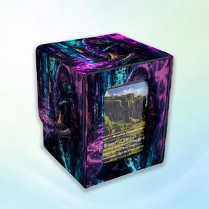 Pode incluir: Uma caixa cúbica para guardar cartas com uma ilustração digital em tons de roxo e azul-petróleo de uma pessoa num cenário urbano escuro. O painel frontal tem um recorte retangular que mostra uma carta de jogo com o texto Mountain Plains Swamp.