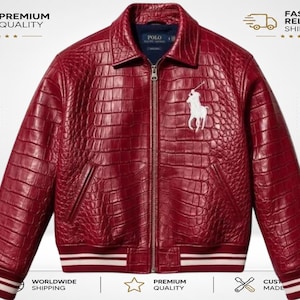 May include: A deep red jacket with a textured crocodile-embossed finish, featuring a full-length front zipper, a classic collar, and a white embroidered Polo Ralph Lauren horse logo on the chest. The cuffs and hem have white striped detailing.
