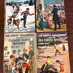 May include: Four vintage hardcover books titled The Happy Hollisters at Snowflake Camp, The Old Clipper Ship, The Cuckoo Clock Mystery, and The Sea Turtle Mystery by Jerry West, featuring colorful illustrated dust jackets with various scenes.