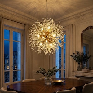 May include: A spherical chandelier featuring a gold-toned central core with numerous radiating metal branches tipped with small, clear crystal-like beads. The fixture emits a warm, bright glow, illuminating the surrounding space with light.
