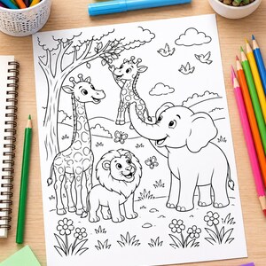A black and white coloring page featuring a giraffe, a lion, and an elephant in a forest setting with trees, flowers, butterflies, and birds. The page is surrounded by colored pencils, markers, and a small potted succulent plant.