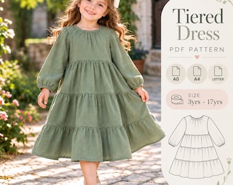 May include: A sage green long-sleeved tiered dress with a round neckline and gathered skirt sections. The image includes text reading Tiered Dress PDF Pattern, A0, A4, LETTER, and SIZE 3yrs - 17yrs, alongside a black and white line drawing of the dress.