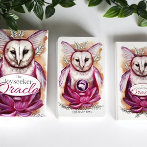 Pink and purple tarot and oracle cards featuring animals, flowers, plants and crystals.