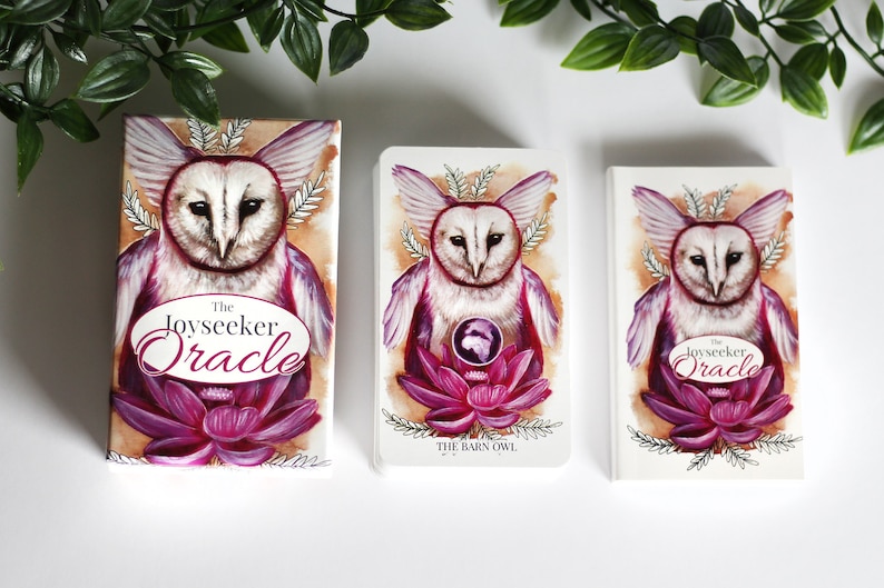 Pink and purple tarot and oracle cards featuring animals, flowers, plants and crystals.