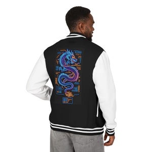 May include: A black varsity jacket with white sleeves and a black ribbed collar, cuffs, and hem featuring white stripes. The back displays a large, colorful neon-style dragon graphic surrounded by technical text and data-like orange and blue lines.