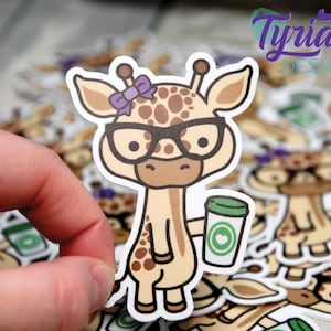 May include: A sticker of a cartoon giraffe wearing glasses and a purple bow, holding a cup of coffee with a heart on it.