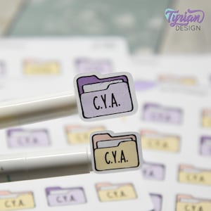 May include: Small, colorful stickers featuring a folder design with the text "C.Y.A." in a handwritten font. The stickers are in shades of purple, peach, and yellow. The stickers are on a white background.