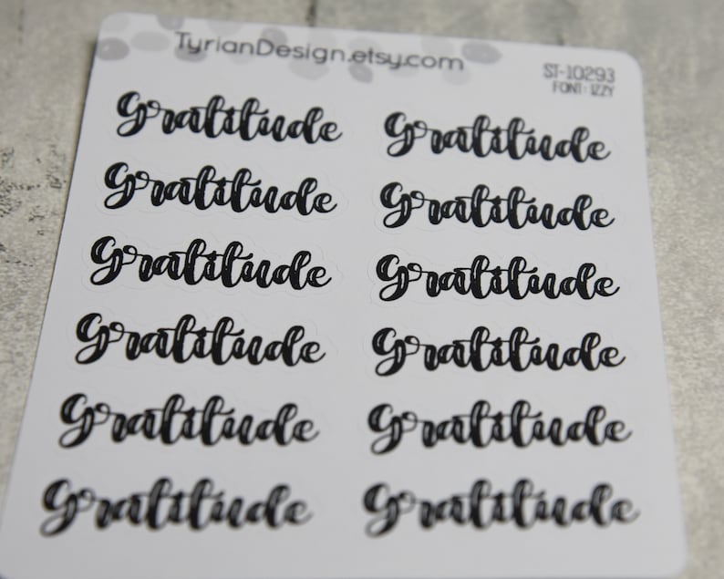 May include: Ten black and white stickers with the word "Gratitude" written in a cursive font. The stickers are on a white background.