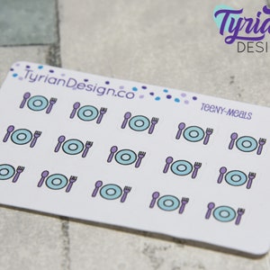 May include: A sheet of 15 stickers featuring a blue plate, purple fork and spoon. The text "TEENY-MEALS" is printed on the sheet.