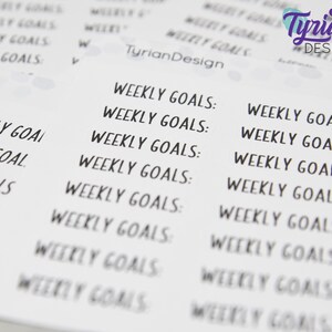 May include: A sheet of printable stickers with the text "Weekly Goals" repeated multiple times in a handwritten font. The stickers are designed for use in a planner or journal.