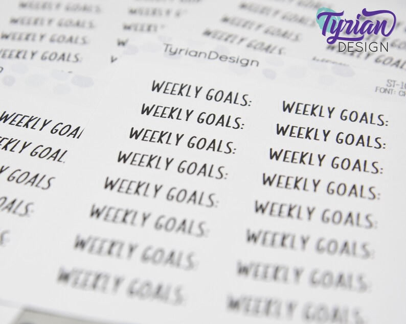 May include: A sheet of printable stickers with the text "Weekly Goals" repeated multiple times in a handwritten font. The stickers are designed for use in a planner or journal.