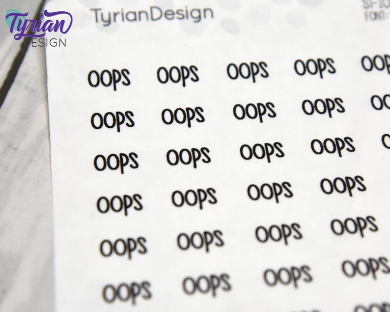 May include: A sheet of white sticker paper with multiple black "oops" stickers printed on it. The stickers are arranged in a grid pattern.