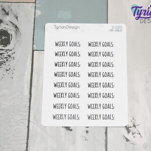 May include: A sheet of white sticker paper with the text "Weekly Goals:" repeated 14 times in black text.