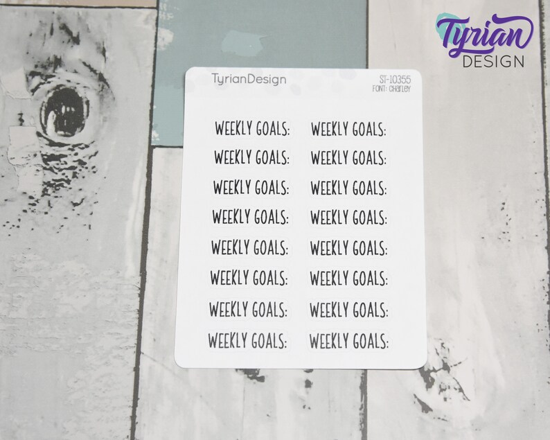 May include: A sheet of white sticker paper with the text "Weekly Goals:" repeated 14 times in black text.