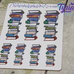 May include: A sheet of stickers featuring stacks of colorful books. The stickers are perfect for adding a touch of whimsy to planners, journals, and other paper crafts.