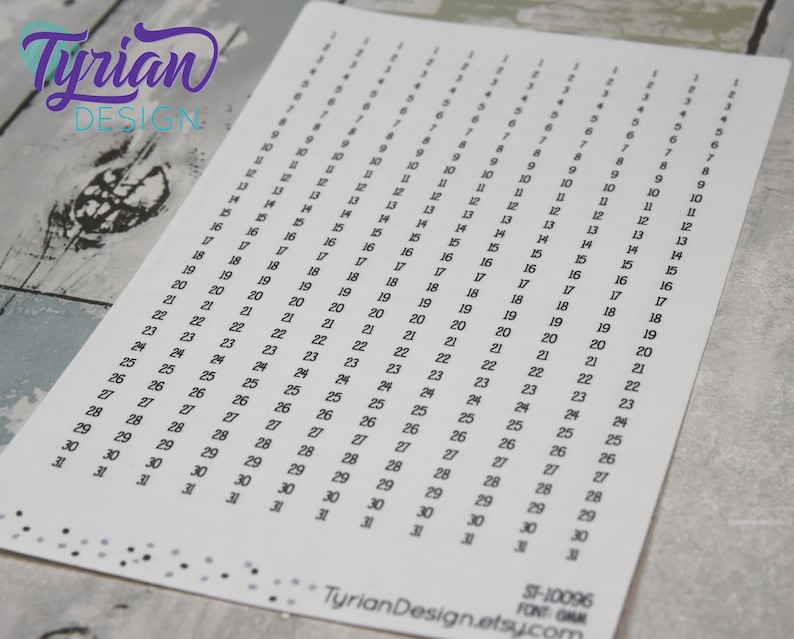 May include: A sheet of white paper with black numbers from 1 to 31 printed in columns. The numbers are arranged in a calendar format, with each column representing a day of the month.