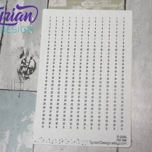 May include: A white printable sheet with numbers 1 through 31 repeated 31 times in a grid pattern. The sheet is designed for use with a planner or bullet journal. The sheet has a subtle speckled pattern.