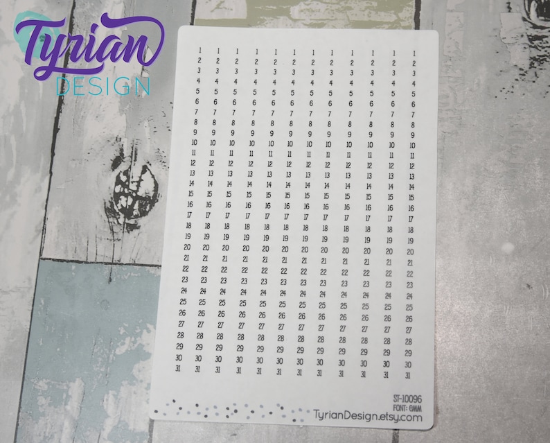 May include: A white printable sheet with numbers 1 through 31 repeated 31 times in a grid pattern. The sheet is designed for use with a planner or bullet journal. The sheet has a subtle speckled pattern.