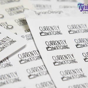 May include: A sheet of white stickers with the text "Currently Watching" and a small television icon. The stickers are designed for use in a planner or journal.