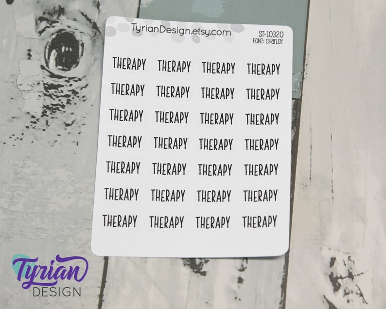 May include: A sheet of white sticker paper with the word "THERAPY" repeated 24 times in black text. The text is in a simple, handwritten font. The sticker sheet is labelled "ST-10320" and "FONT: CHARLEY".