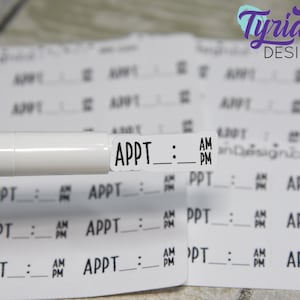 May include: A white marker pen with black text that reads "APPT: AM PM" is placed on top of a sheet of white paper with multiple labels that read "APPT: AM PM".