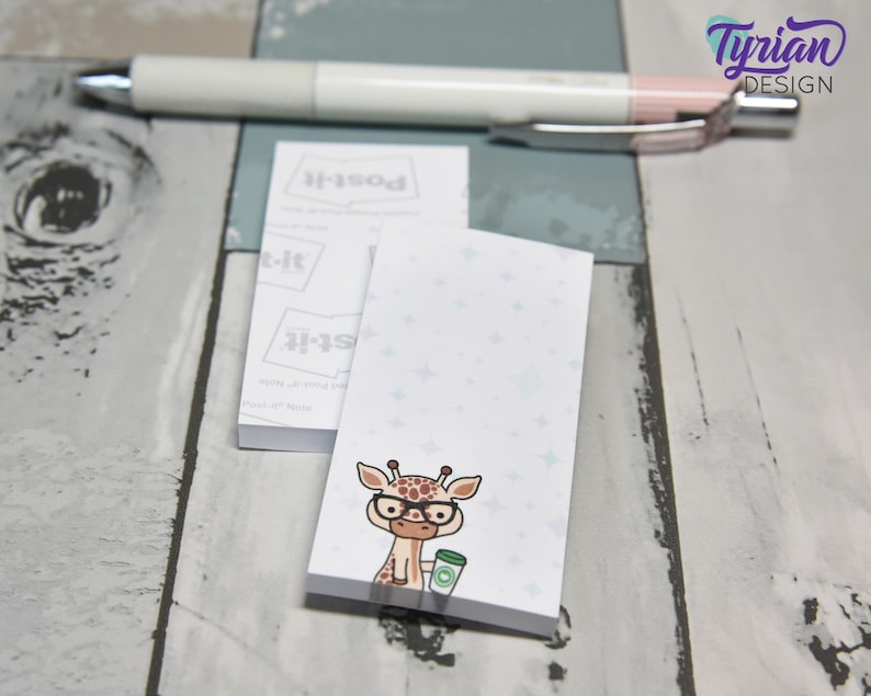 May include: A white notepad with a light blue background and a cartoon giraffe wearing glasses and holding a cup of coffee. The notepad has the text "Post-it" printed on it.