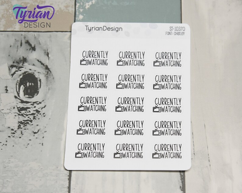 May include: A sheet of 15 white stickers with black text and a small television icon. Each sticker says "CURRENTLY WATCHING".