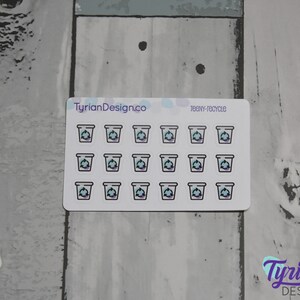 May include: A sheet of 20 small, white, sticker-like labels with a blue and purple recycling symbol inside a black outline of a cup. The text "teeny-recycle" is printed in black at the top of the sheet. The text "TyrianDesign.co" is printed in black at the top left of the sheet.