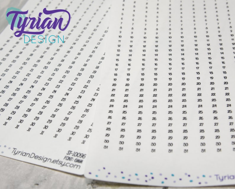 May include: A white sheet of paper with a grid of numbers from 1 to 31, repeated across the page. The numbers are in black ink and are written in a cursive font. The text "Tyrian DESIGN" is at the top of the page in a purple cursive font. The text "ST-10096 FONT: GMM TyrianDesign.etsy.com" is at the bottom of the page.
