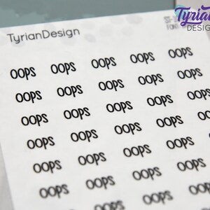May include: A sheet of white sticker paper with multiple black "OOPS" stickers printed on it. The stickers are arranged in rows and columns.
