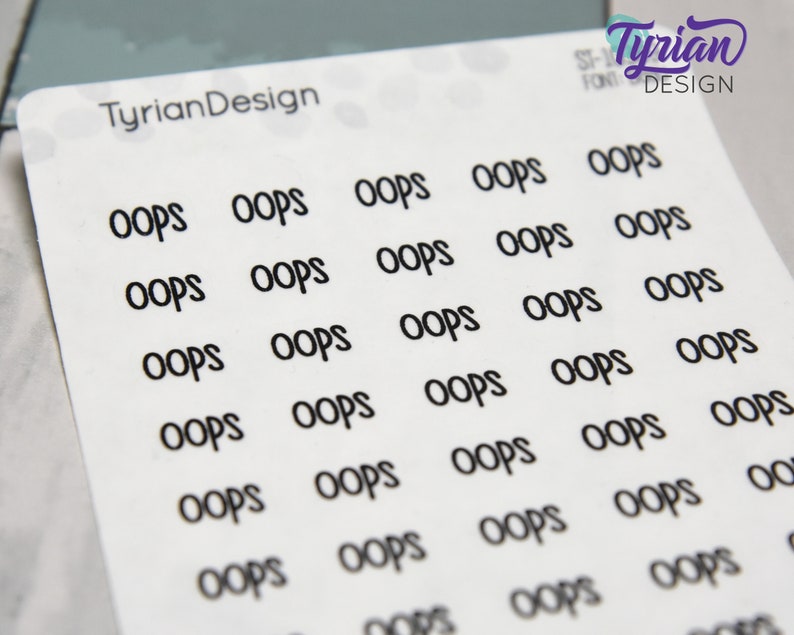 May include: A sheet of white sticker paper with multiple black "OOPS" stickers printed on it. The stickers are arranged in rows and columns.