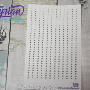 May include: A white sheet of paper with black numbers from 1 to 31 printed in columns. The numbers are repeated in each column, creating a grid pattern. The paper has a subtle gradient effect, with the numbers at the bottom appearing slightly darker than those at the top. The text "Tyrian Design" and "ST-10096" is printed at the bottom of the sheet.