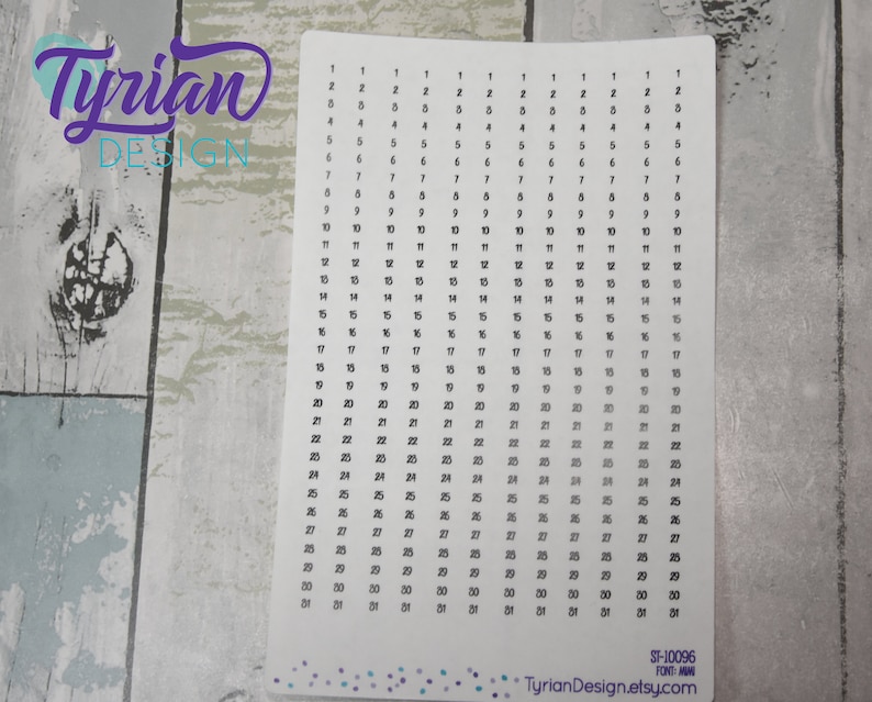 May include: A white sheet of paper with black numbers from 1 to 31 printed in columns. The numbers are repeated in each column, creating a grid pattern. The paper has a subtle gradient effect, with the numbers at the bottom appearing slightly darker than those at the top. The text "Tyrian Design" and "ST-10096" is printed at the bottom of the sheet.