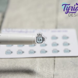 May include: A sheet of stickers with a white background and a blue teacup design. The teacup has the word "TEA" inside and steam coming from the top. The stickers are arranged in a grid pattern.